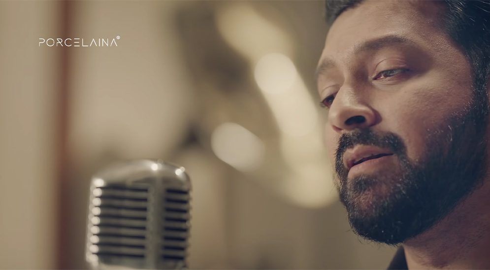 A musician singing at a vintage microphone in a Porcelaina campaign film