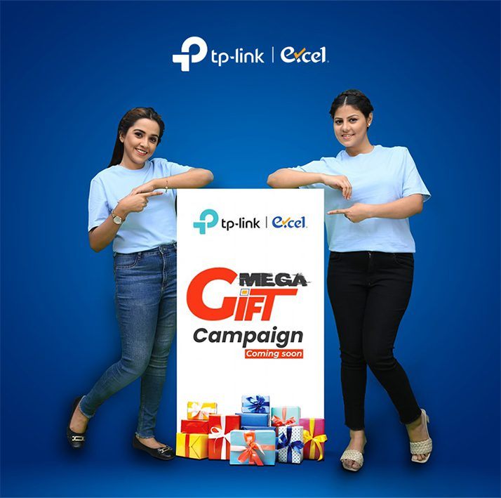 Two women presenting the TP-Link Mega Gift Campaign board
